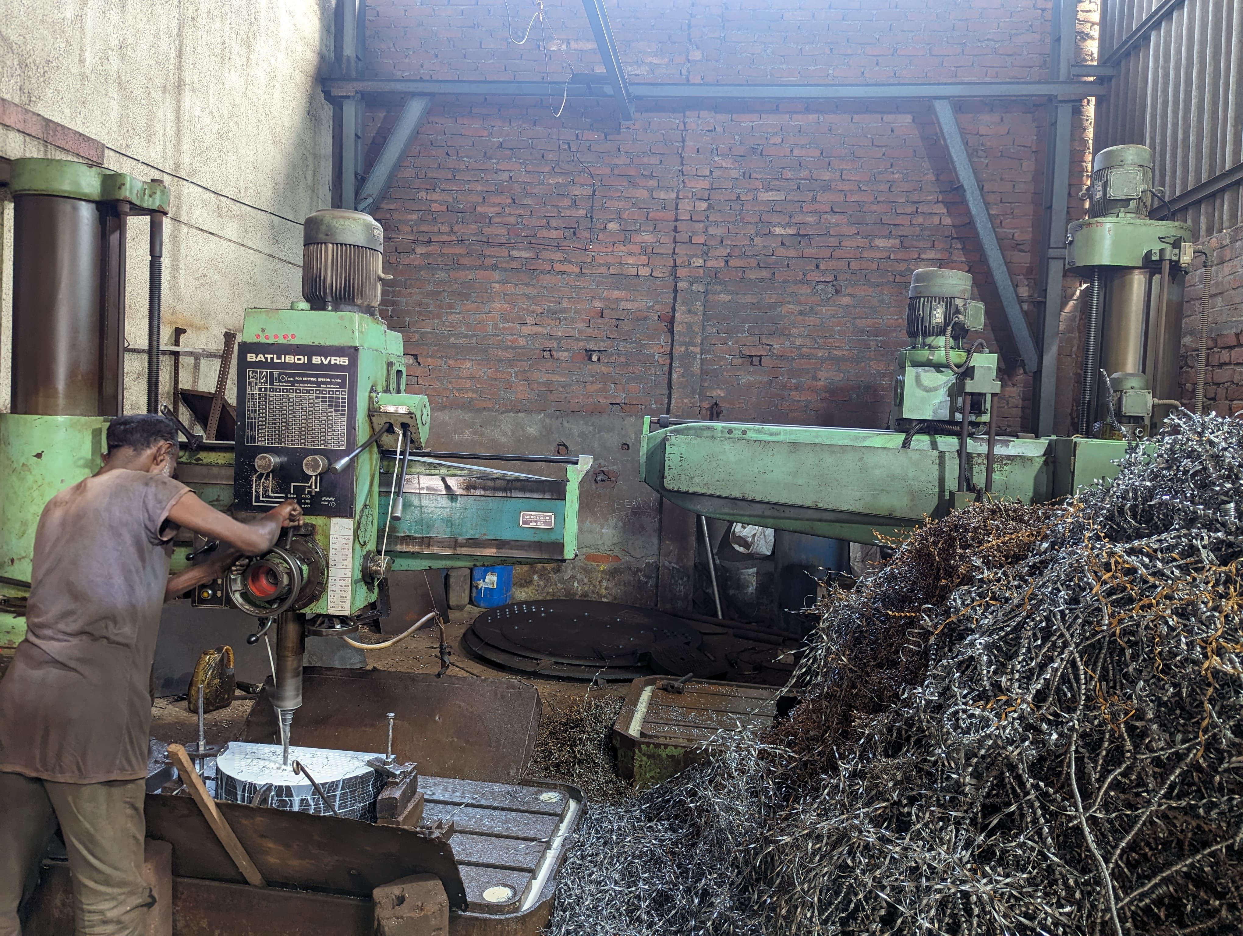 Worker operating radial drill machine for tubesheet drilling job work at Dipsha Industries